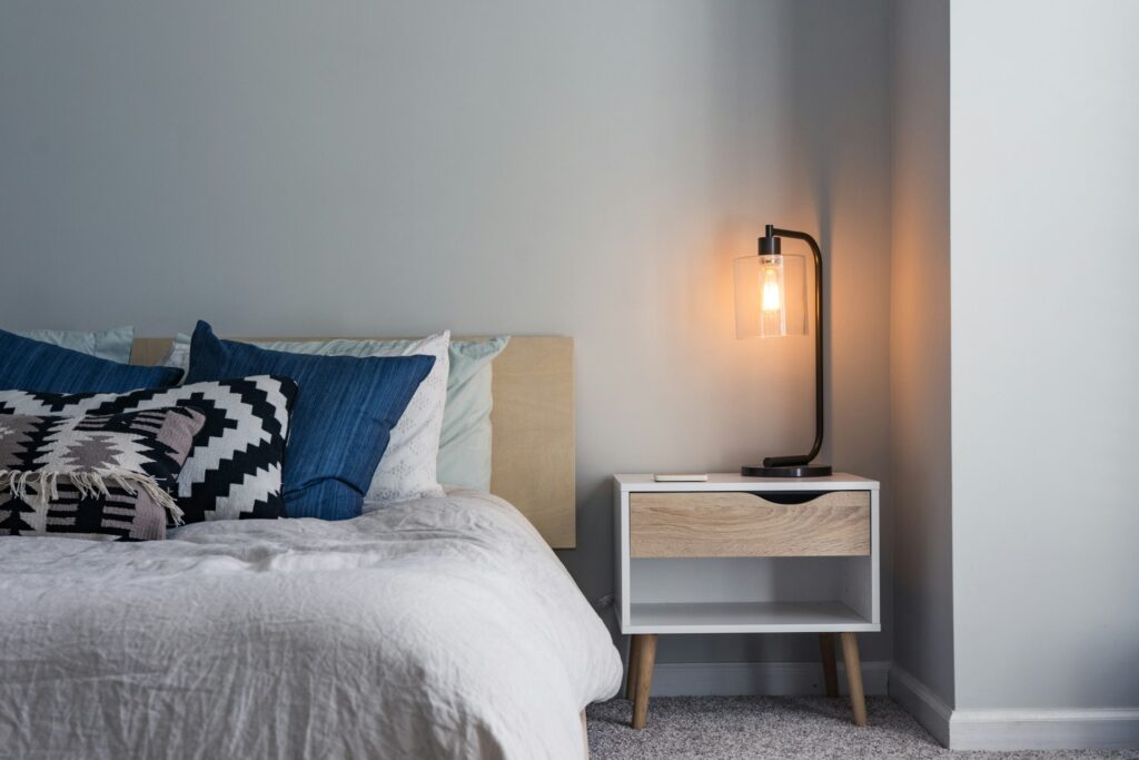 always tired and exhausted - cozy bedroom with glowing lamp and pillows